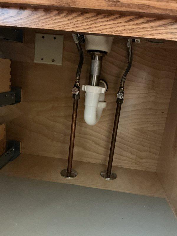 Performed Club inspection and diagnosed short cycling well issue. Installed warranty tub faucet parts from Moen (currently awaiting additional parts with approximately 2-week lead time). Inspected under-sink plumbing assembly, confirming proper installation of P-trap and supply lines with no visible leaks or damage.