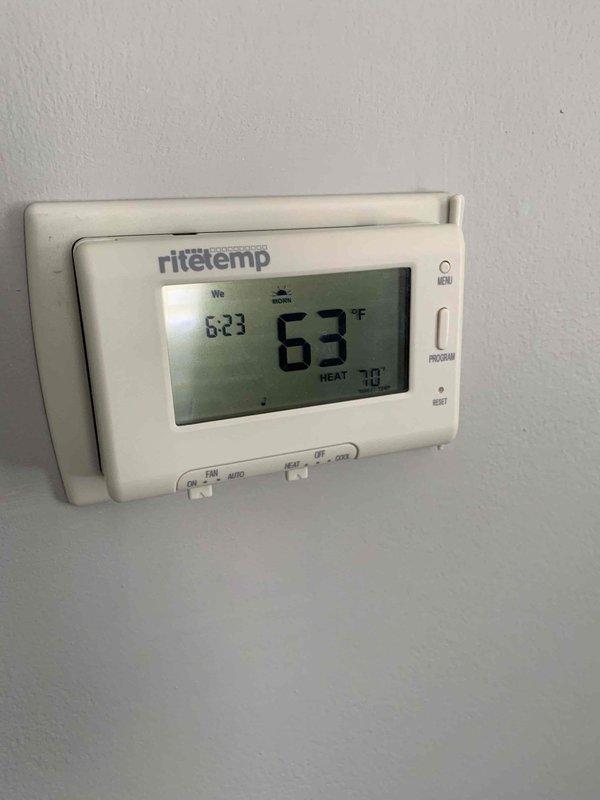 Inspected heating system due to temperature discrepancy between floors. Identified thermostat inconsistency between Ritetemp unit (reading 63°F) and Hunter unit (reading 66°F). Confirmed first floor heating operational while second floor remains cold, suggesting possible zone control or balancing issue in the multi-zone system.