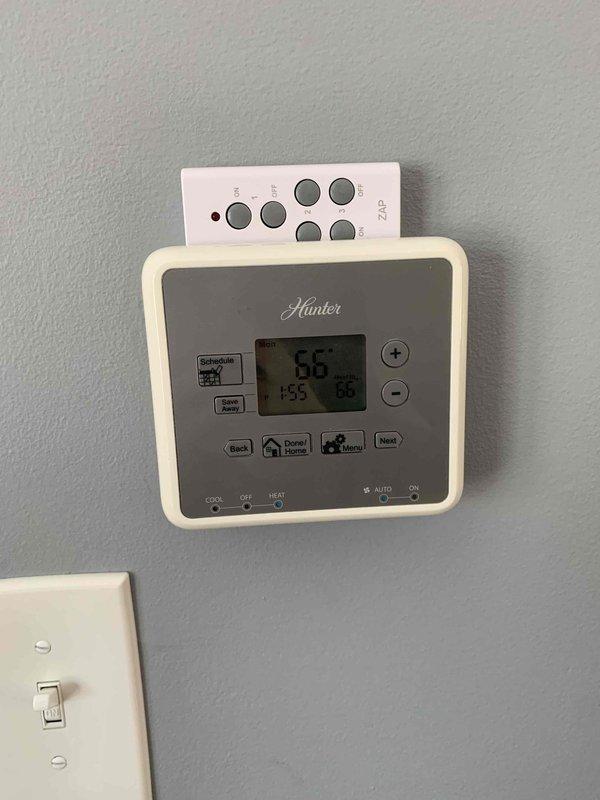 Inspected heating system due to temperature discrepancy between floors. Identified thermostat inconsistency between Ritetemp unit (reading 63°F) and Hunter unit (reading 66°F). Confirmed first floor heating operational while second floor remains cold, suggesting possible zone control or balancing issue in the multi-zone system.