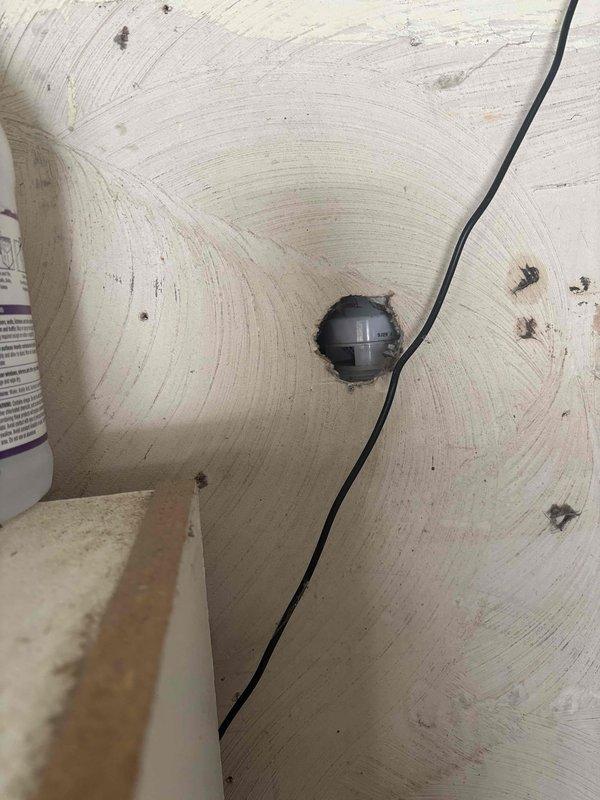 Responded to customer complaint of sewer smell near washer, which was a recurring issue previously addressed with vent installation. Inspected the plumbing ventilation system in the wall/ceiling area and examined wooden structural elements in the surrounding space to ensure proper air circulation and eliminate odor source.