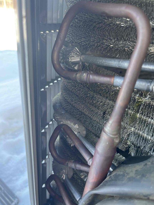 Performed warranty service on heat pump system. Diagnosed evaporator coil with significant frost buildup and ice formation on refrigerant lines. Corrected refrigerant charge and cleaned coil surfaces to restore proper heat exchange functionality and system operation.