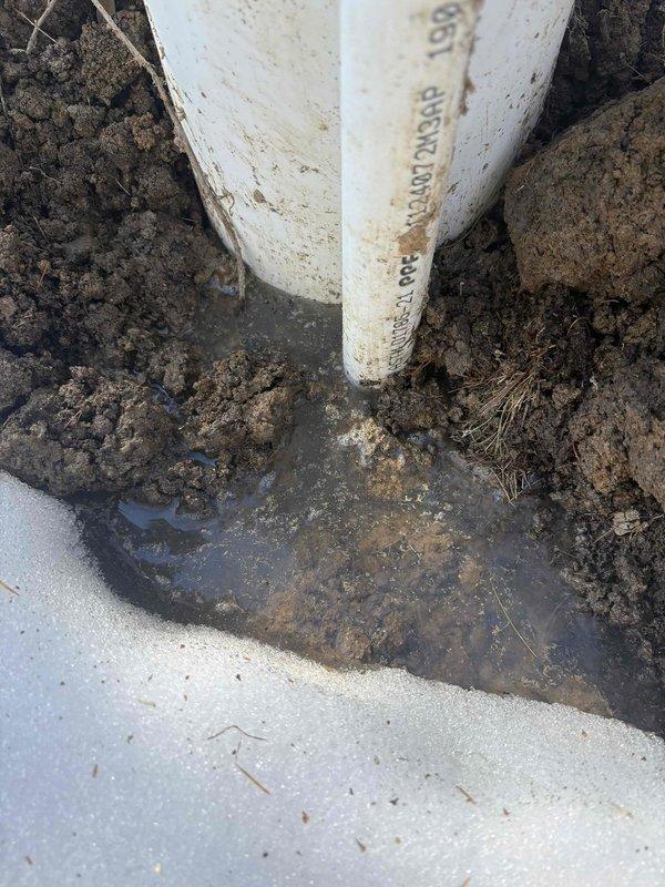 Diagnosed basement water intrusion originating from a leaking PVC water line. Excavated around the affected pipe section where water was visibly pooling in the soil. Repaired the leaking connection and verified proper water flow with no further seepage into the basement area.