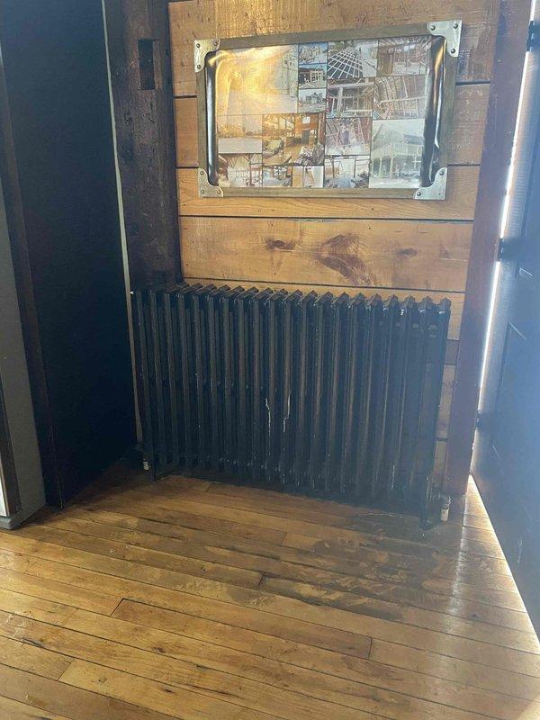 Completed removal of old boiler system with assistance and installed new wall-mounted heating unit with copper supply lines. Connected unit to existing infrastructure with proper mounting hardware and fittings, leaving system ready for water addition and bleeding upon installation of second heater.