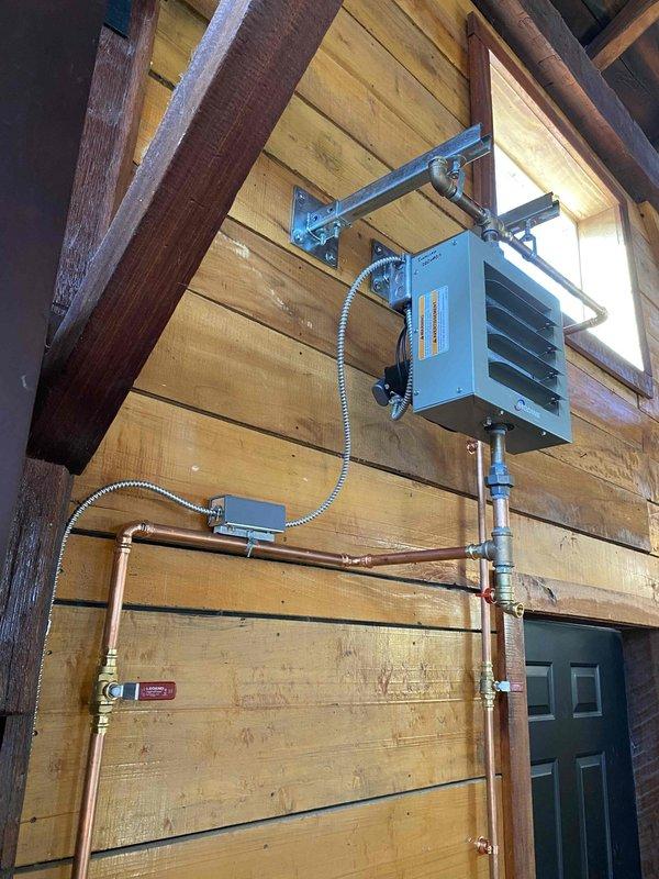 Completed removal of old boiler system with assistance and installed new wall-mounted heating unit with copper supply lines. Connected unit to existing infrastructure with proper mounting hardware and fittings, leaving system ready for water addition and bleeding upon installation of second heater.