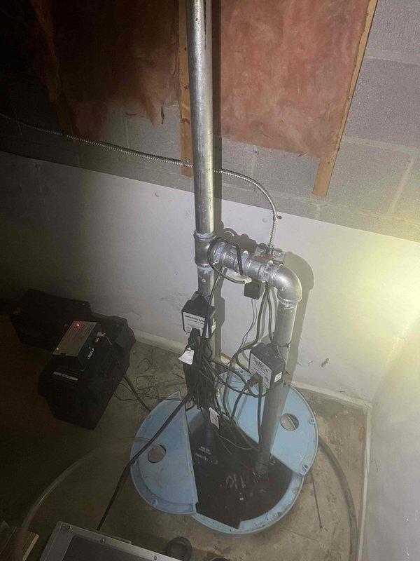 Successfully cleared clogged downspout drainage system using professional snaking equipment. Inspected basement sump pump system which appears properly installed with functioning components. Verified exterior drainage pipes are clear and operating correctly to ensure proper water diversion from the foundation.