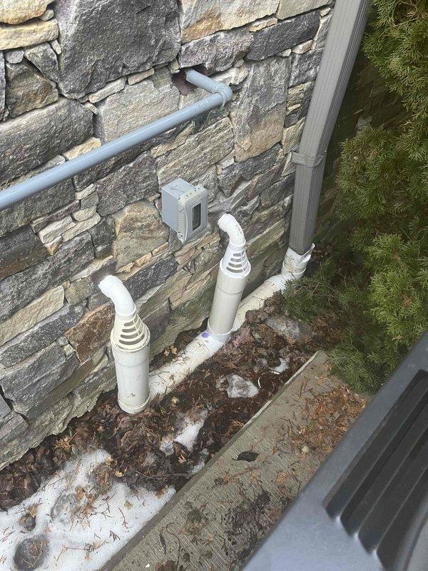 Successfully cleared clogged downspout drainage system using professional snaking equipment. Inspected basement sump pump system which appears properly installed with functioning components. Verified exterior drainage pipes are clear and operating correctly to ensure proper water diversion from the foundation.