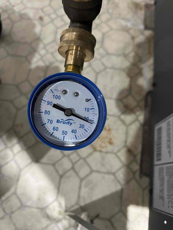 Completed boiler maintenance visit for club member. Inspected Taco NXT ECM high-efficiency circulator pump installation and connections. Verified system pressure at 25 PSI on Brady gauge, confirming proper operation within normal parameters.