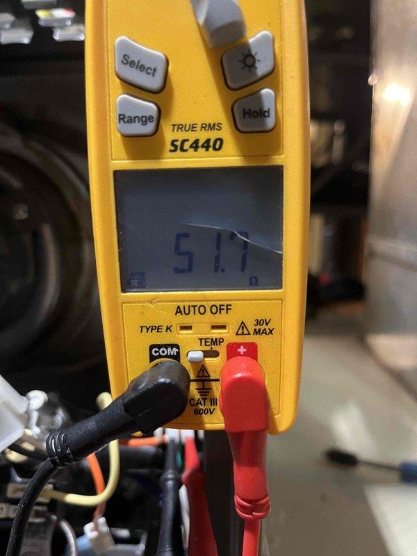 Completed routine air handler maintenance visit. Performed electrical resistance testing with Fieldpiece SC440 multimeter, obtaining 51.7 ohm reading. Accessed and inspected insulated refrigerant lines using hex key tool, confirmed proper insulation integrity with no visible damage.