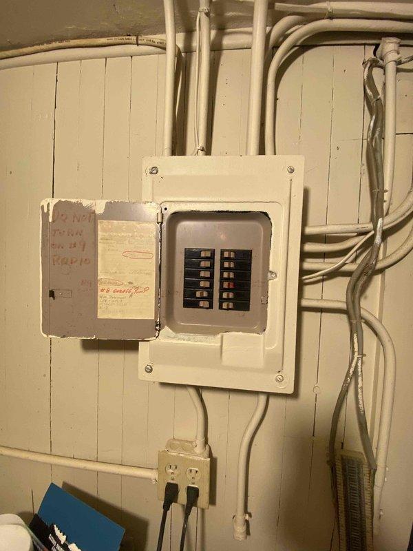 Conducted site assessment for mini-split installation in upstairs rooms and potential replacement of kitchen baseboard heating. Inspected electrical panel capacity and existing boiler system to determine compatibility with proposed HVAC modifications. Photos documented current electrical service configuration and heating infrastructure to support system design recommendations.