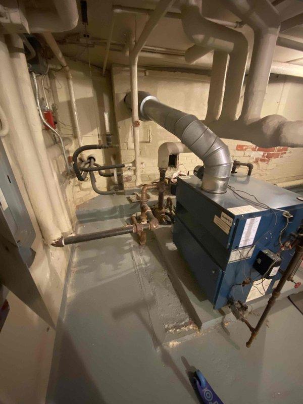 Conducted site assessment for mini-split installation in upstairs rooms and potential replacement of kitchen baseboard heating. Inspected electrical panel capacity and existing boiler system to determine compatibility with proposed HVAC modifications. Photos documented current electrical service configuration and heating infrastructure to support system design recommendations.