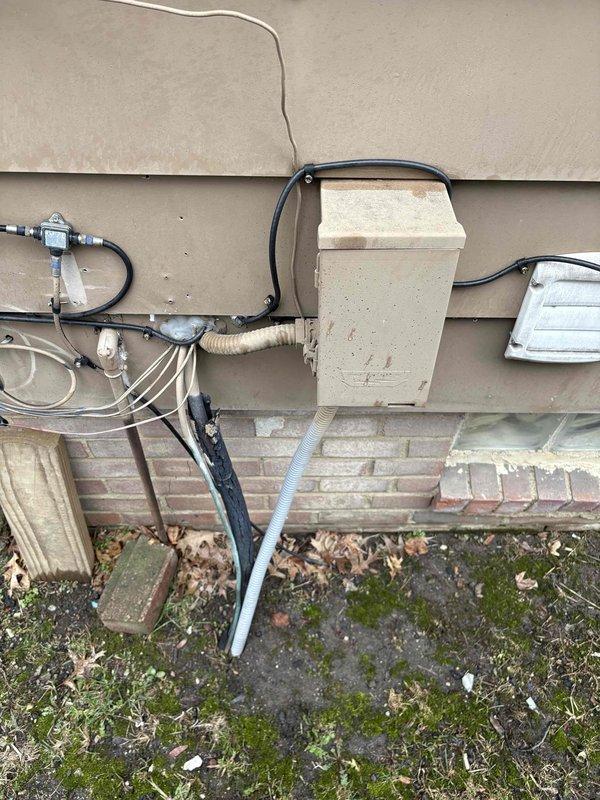 Conducted site evaluation for mini split installation in addition room. Inspected existing HVAC system, including furnace with exposed internal components and associated ductwork in utility area. Examined exterior wall mounting options and current electrical connections to determine optimal placement for new mini split system.