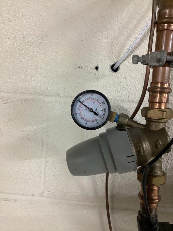 Diagnosed and replaced failed water expansion tank on A.O. Smith water heater system. Discovered rubber particulate contamination in hot water line, performed complete system flush to remove debris. Verified proper pressure readings and system operation after installation.