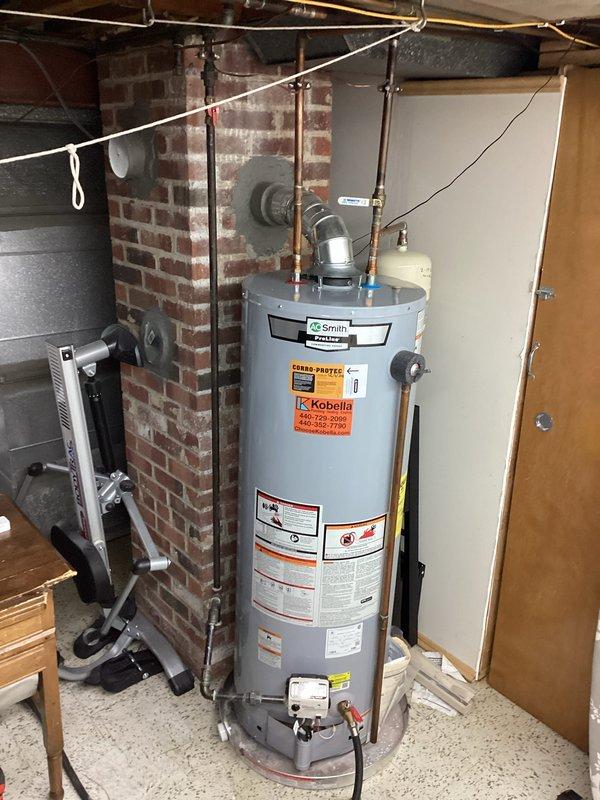 Diagnosed and replaced failed water expansion tank on A.O. Smith water heater system. Discovered rubber particulate contamination in hot water line, performed complete system flush to remove debris. Verified proper pressure readings and system operation after installation.