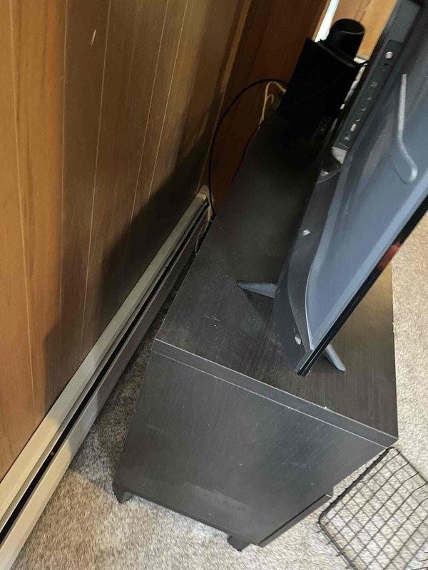 Conducted inspection of baseboard heating system to assess customer's concerns about radiators. Observed visible wear and damage at corner junction of baseboard heater cover with signs of separation. Evaluated confined installation space between wall and furniture that may be affecting proper heat distribution. Recommended options for repair versus replacement based on current system condition.