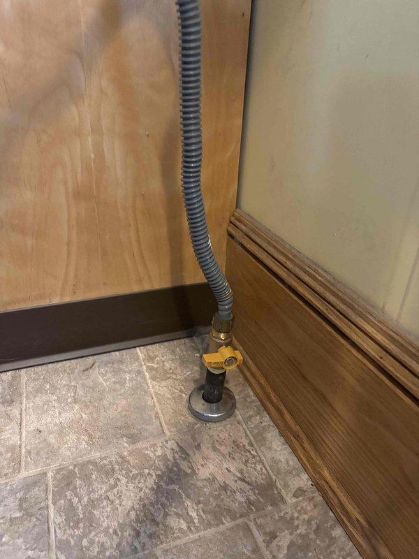 Performed gas leak investigation and confirmed presence of leak at stove connection point. Located severely corroded gas valve with significant rust deterioration at the appliance connection. Gas supply to home was shut off for safety until valve replacement can be completed.