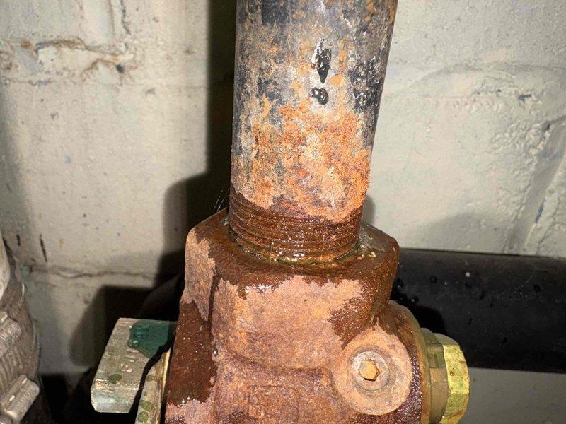 Performed gas leak investigation and confirmed presence of leak at stove connection point. Located severely corroded gas valve with significant rust deterioration at the appliance connection. Gas supply to home was shut off for safety until valve replacement can be completed.