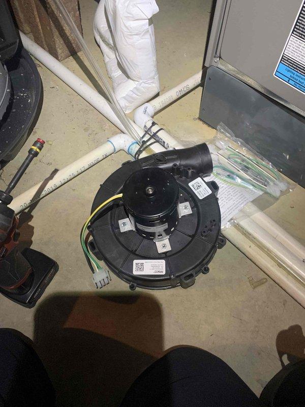 Completed warranty service on HVAC system, replacing a defective blower motor assembly. Removed the old black plastic wheel housing unit with damaged hub, installed new motor with proper electrical connections, and verified proper operation of the system after installation.
