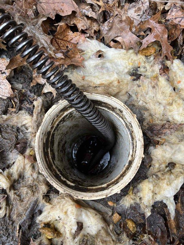 Successfully performed main drain cleanout using snake tool to clear blockage in PVC drain pipe. Accessed outdoor drainage system, removed accumulated debris, and conducted inspection to ensure proper water flow was restored.