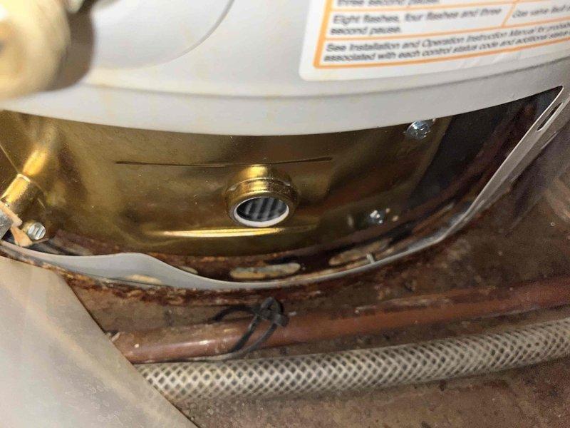 Diagnosed BW gas water heater displaying flammable vapor sensor fault code. Inspected unit showing significant corrosion around brass/copper interface components, with contrasting new parts visible. Confirmed proper operation of ignition system as evidenced by functional blue flame indicator during testing.