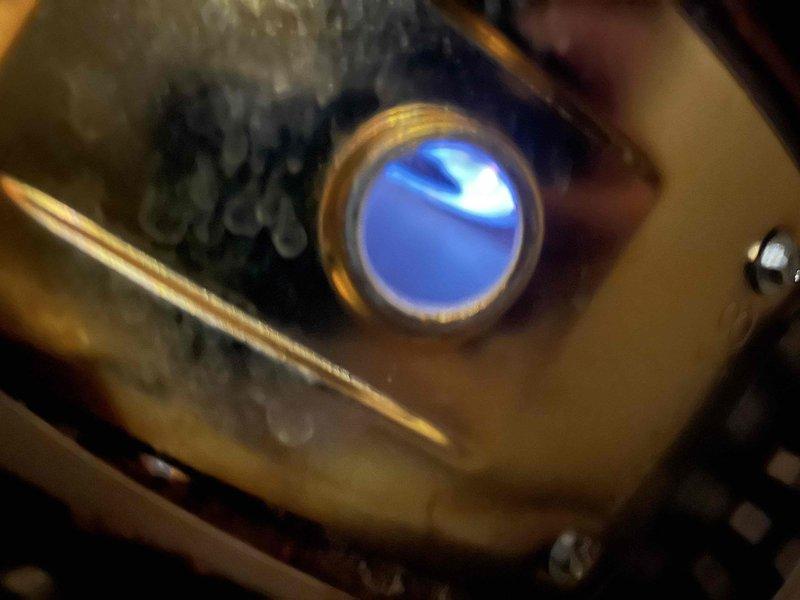 Diagnosed BW gas water heater displaying flammable vapor sensor fault code. Inspected unit showing significant corrosion around brass/copper interface components, with contrasting new parts visible. Confirmed proper operation of ignition system as evidenced by functional blue flame indicator during testing.