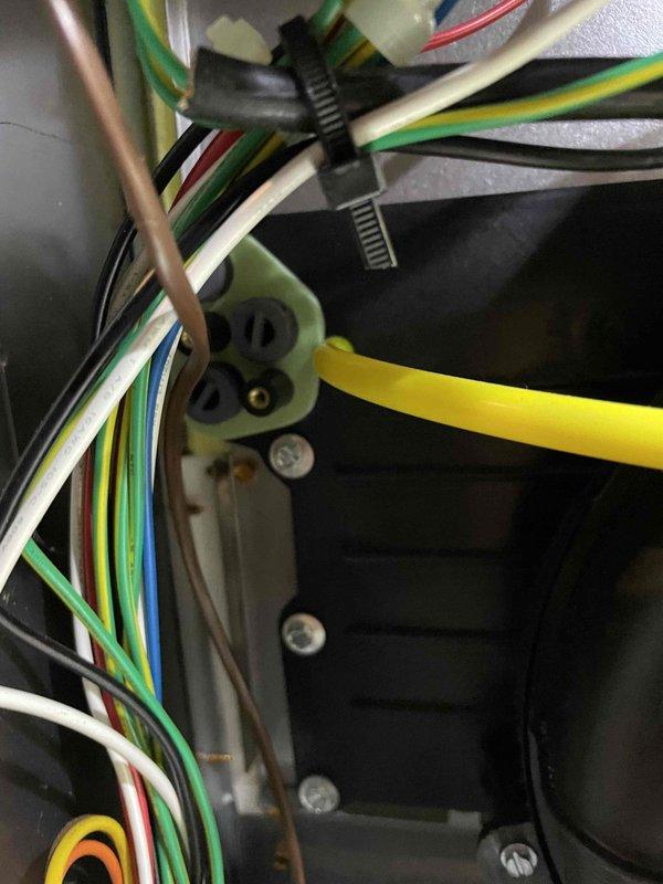 Performed diagnostic on furnace system due to reported heat loss and temperature inconsistency. Inspected Aprilaire whole-house humidifier installation, verifying proper mounting and level positioning. Examined electrical connections including multiple wire bundles (green, yellow, blue, red, white, and black) at terminal block, confirming secure fastening and appropriate routing within the system.