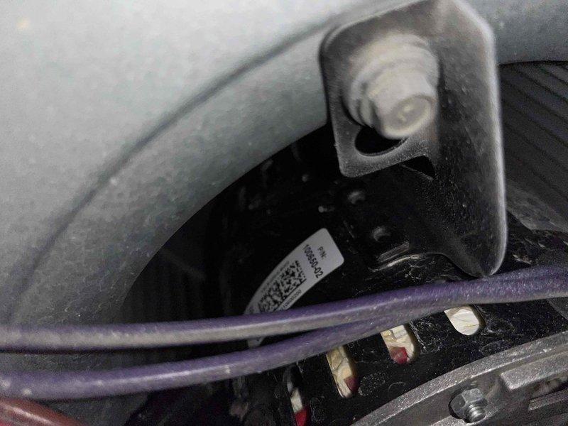 Diagnosed weak airflow issue in furnace. Inspected control board and wiring connections, documenting status with photos of terminal connections and internal circuit board. Found loose wire connections at control module which were secured to restore proper system operation.