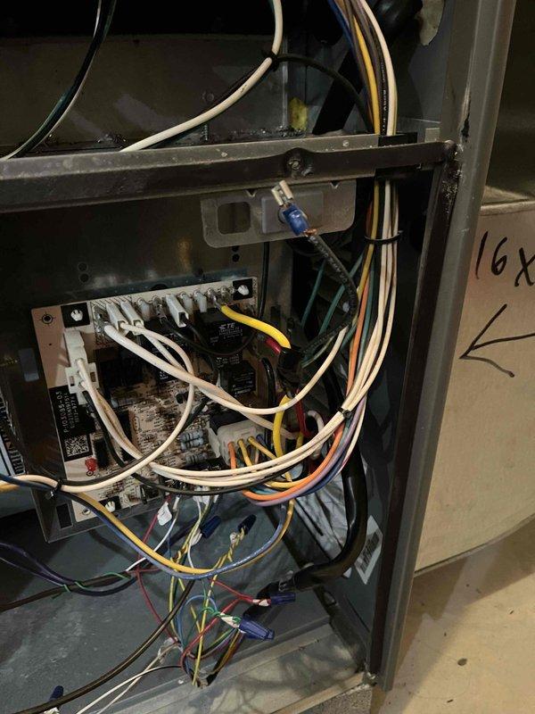 Diagnosed weak airflow issue in furnace. Inspected control board and wiring connections, documenting status with photos of terminal connections and internal circuit board. Found loose wire connections at control module which were secured to restore proper system operation.