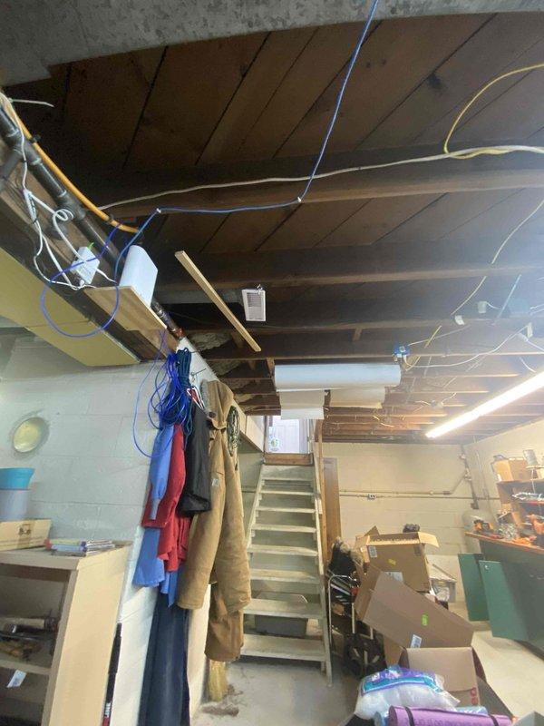 Measured and inspected existing HVAC ductwork system in basement area for the addition of a new supply run. Evaluated the 6-inch insulated main duct and surrounding infrastructure to determine optimal connection point for the new AH branch line. Documented existing conditions including clearance requirements and potential routing through joists to complete the requested ductwork extension.