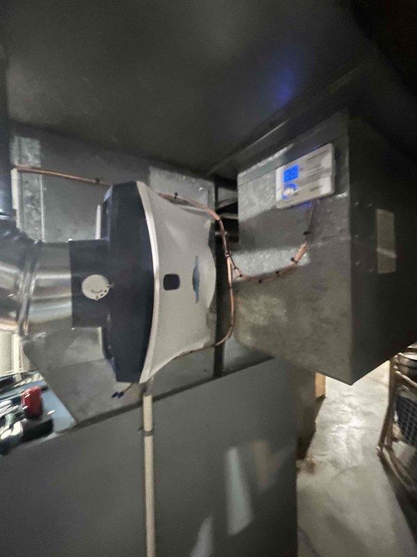 Successfully installed Aprilaire 720 Humidifier on existing HVAC system in utility area. Connected unit to furnace ductwork with proper copper piping configuration, and verified digital control panel functionality. Completed installation and documented with photographs of final setup showing proper integration with the main furnace unit.