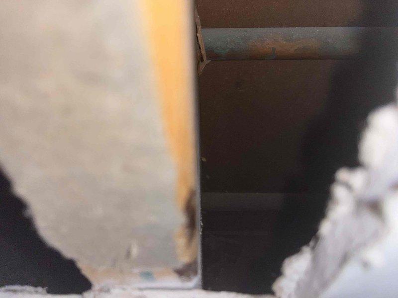 Responded to emergency water leak affecting ceiling below bathroom. Inspected structural framing where water damage was evident in wooden joists and surrounding materials. Repaired main shut-off valve which was identified as the source of the leak, preventing further water intrusion and structural damage.