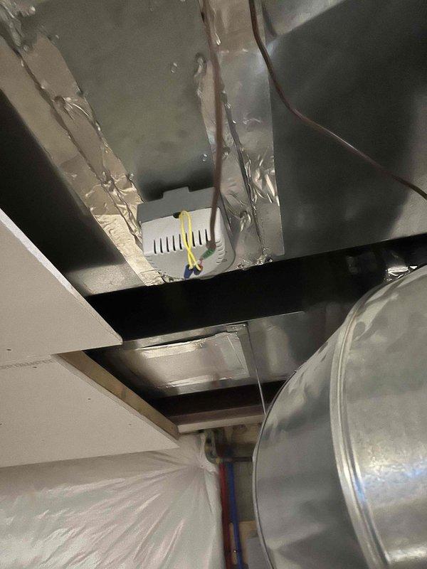 Responded to service call for whistling sound on first floor when second floor HVAC system operates. Inspected zone damper system and identified loose ductwork connections causing air leakage. Sealed joints with aluminum tape and verified proper operation of Aprilaire humidity control unit mounted on air handler.