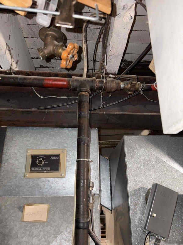 Inspected existing heating system, which consists of an aging Thatcher furnace with no current AC capabilities. Unit is operational but outdated. Customer expressed interest in adding air conditioning. Documented current installation configuration including control interfaces, piping connections, and mechanical room layout to prepare comprehensive replacement estimate for both heating system upgrade and new AC installation.