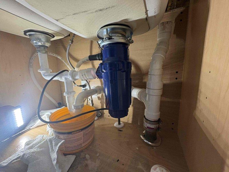 Responded to service call for kitchen sink clog. Performed drain cleaning procedure on affected sink, collecting significant amount of dark sludge and debris in containment vessel. Successfully restored proper drainage function to kitchen plumbing system.
