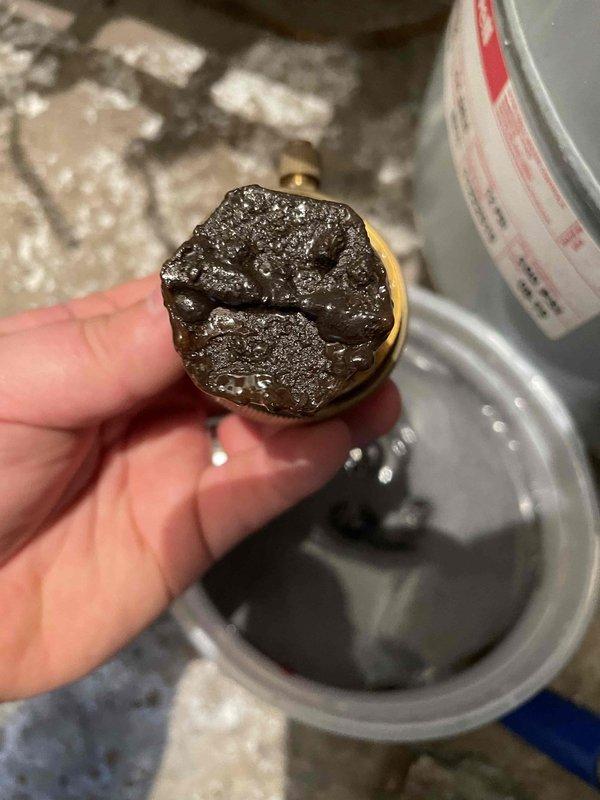 Performed standard heating maintenance on combi system. Removed and cleaned valve with significant residue buildup. Conducted electrical diagnostics with clamp meter showing 0.58A current draw on system components, confirming proper operation within specifications.