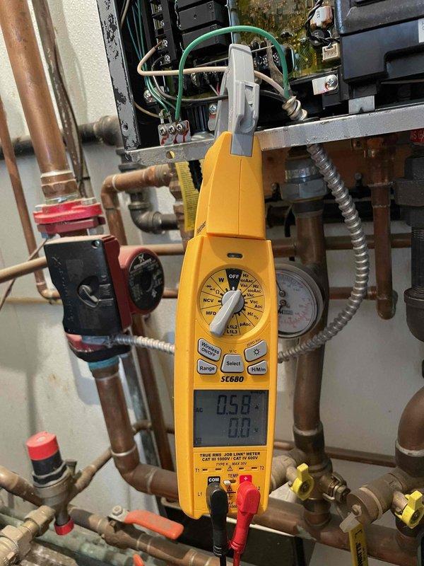 Performed standard heating maintenance on combi system. Removed and cleaned valve with significant residue buildup. Conducted electrical diagnostics with clamp meter showing 0.58A current draw on system components, confirming proper operation within specifications.