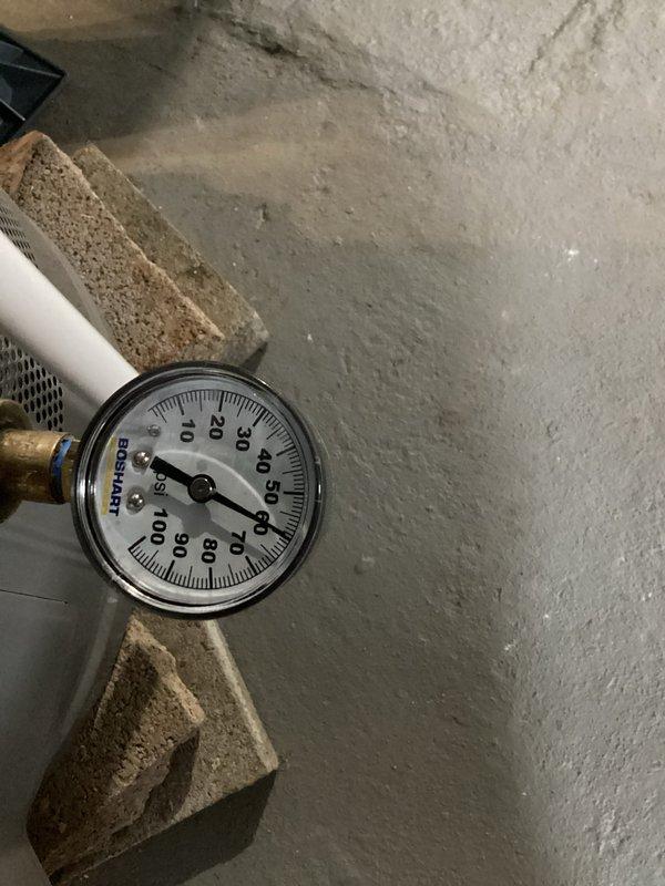 Investigated customer complaint of loud noise from existing sump pump during operation termination. Inspection revealed normal pressure reading of approximately 30-35 PSI on the system gauge. Determined noise is characteristic of this particular model and not indicative of mechanical failure or improper installation.