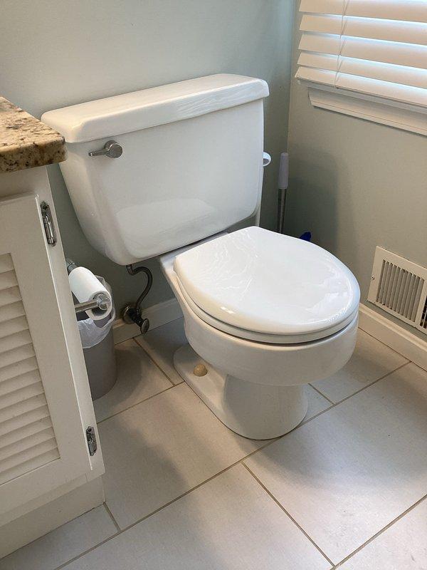 Provided on-site estimate for toilet replacement in a well-maintained bathroom featuring a standard white porcelain toilet with tank. Customer initially requested boiler replacement quote but clarified need for toilet replacement during appointment scheduling.