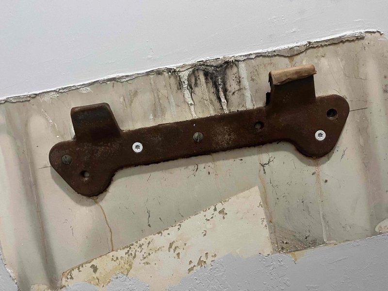 Returned to site to remount a previously sold wall-mounted sink. Discovered significant rust and deterioration on the original mounting bracket, along with water damage to the surrounding wall area. Removed corroded hardware, installed new mounting bracket, and securely reattached sink to ensure proper support and stability.
