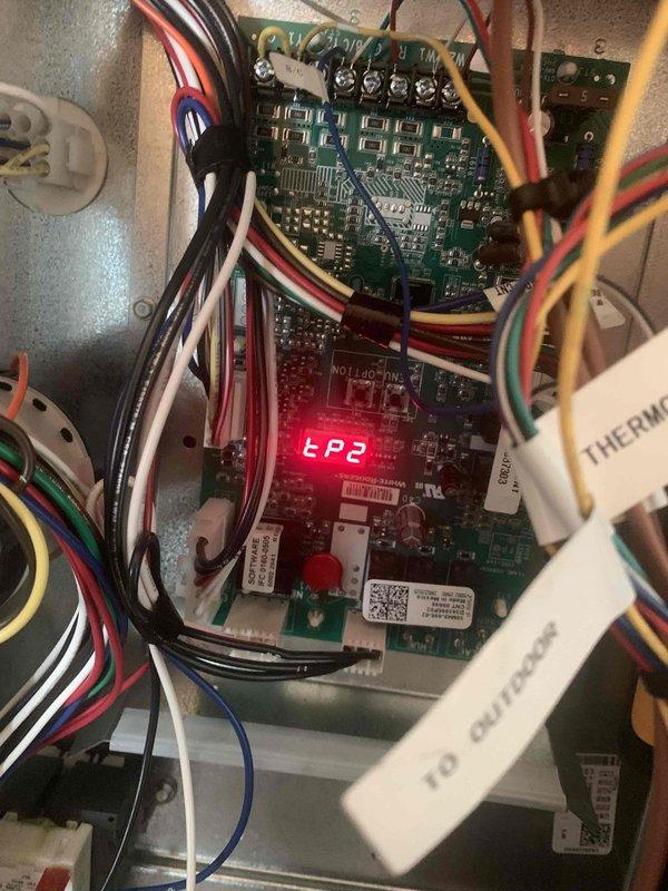 Performed heating maintenance on member's system. Conducted electrical testing with multimeter showing 2.5 reading and inspected control board which displayed "EP2" error code. Documented diagnostic findings with photos of electrical components and control board wiring connections.