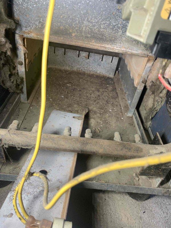 Performed boiler maintenance service visit. Conducted voltage testing with Fieldpiece SC480 multimeter, measuring 25.7 volts. Identified significant dust and debris accumulation throughout system components, with visible surface corrosion and deterioration of metal structures requiring attention.