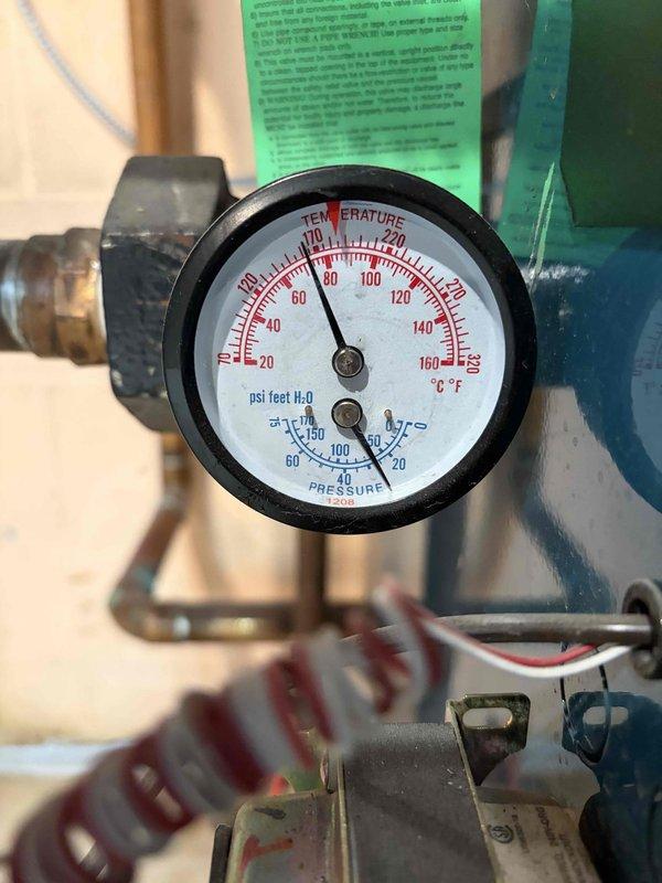 Repaired leaking pipe on aging boiler system. Inspection revealed compromised connection at pipe junction with hex nuts. System operating at approximately 80-90°F with pressure reading 20-30 PSI after service completion.