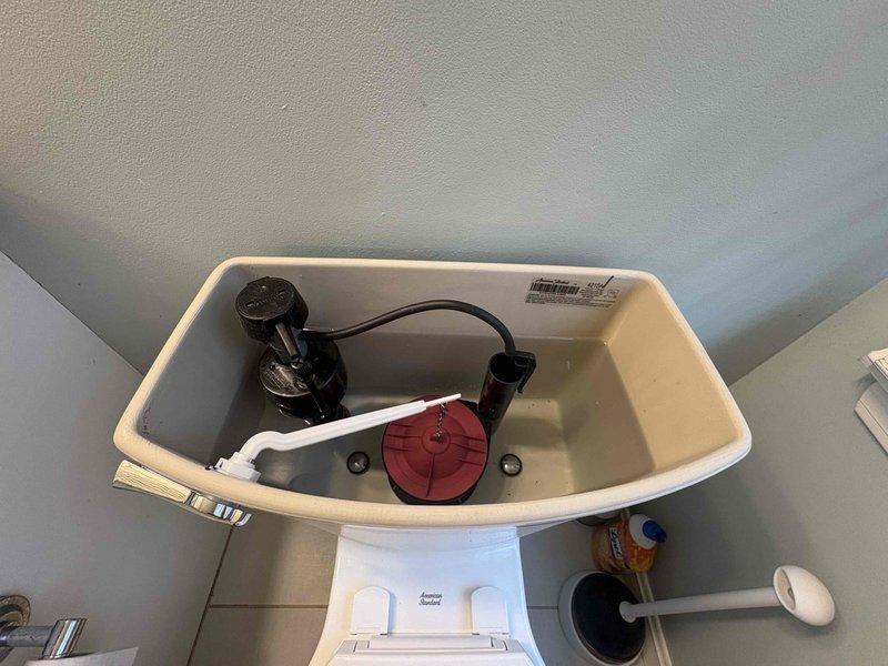 Returned to complete installation of customer-supplied toilet. Inspected internal tank components including flush valve, flapper, and fill valve - all in proper working condition. Secured toilet base to floor with mounting bolts and verified no leaks at connections.