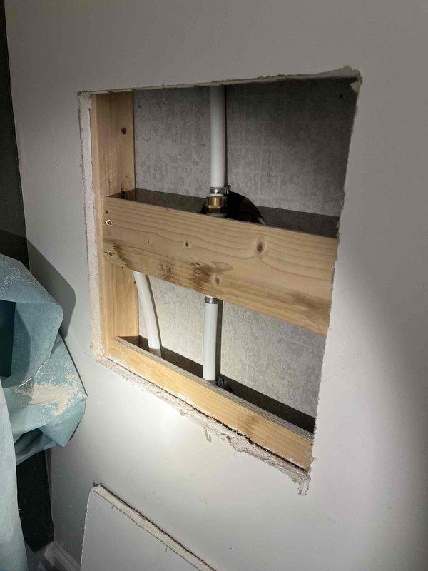 Identified and repaired shower leak within wall cavity. Removed section of drywall to access plumbing infrastructure, revealing water intrusion around shower diverter valve connection. Replaced damaged valve fitting and verified proper operation with no further leakage before closing access point.