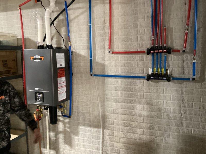 Successfully completed warranty replacement of defective tankless water heater, properly installing and connecting the new unit to existing plumbing infrastructure with color-coded pipes. Verified proper function of the digital control panel and ensured all connections were secure with no leaks present upon system pressurization and testing.