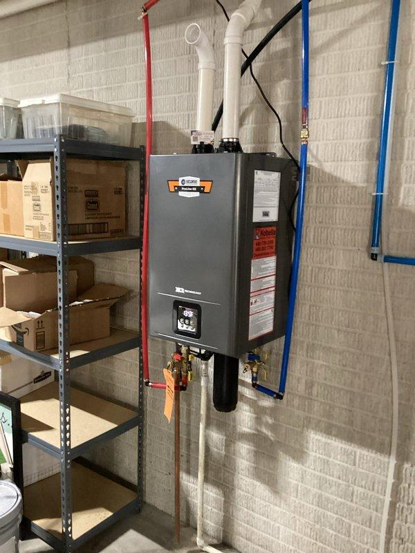 Successfully completed warranty replacement of defective tankless water heater, properly installing and connecting the new unit to existing plumbing infrastructure with color-coded pipes. Verified proper function of the digital control panel and ensured all connections were secure with no leaks present upon system pressurization and testing.