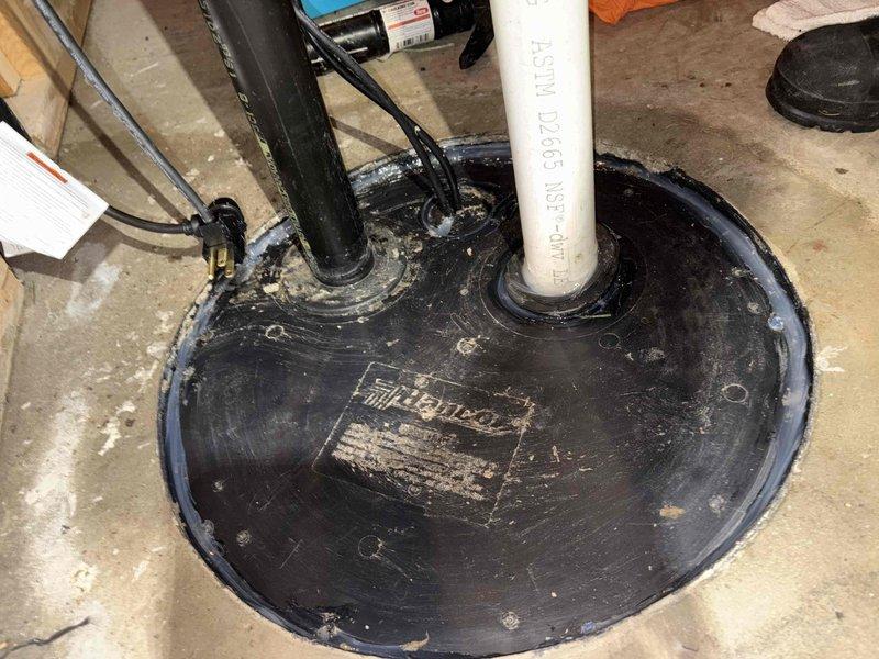 Replaced malfunctioning sump pump with new 65W model that was leaking at discharge connection. Inspected basin interior, found debris and residue causing improper sealing. Cleaned basin, reseated discharge pipe, and confirmed proper operation with no further water leakage.