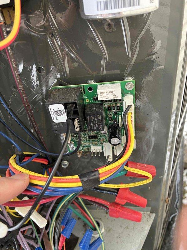 Performed diagnostic on system and identified faulty coil sensor reading low. Inspected control board and wiring connections in electrical panel. Ordered replacement temperature sensor and defrost board to resolve issue. Documented condition with photos of circuit board and electrical components.