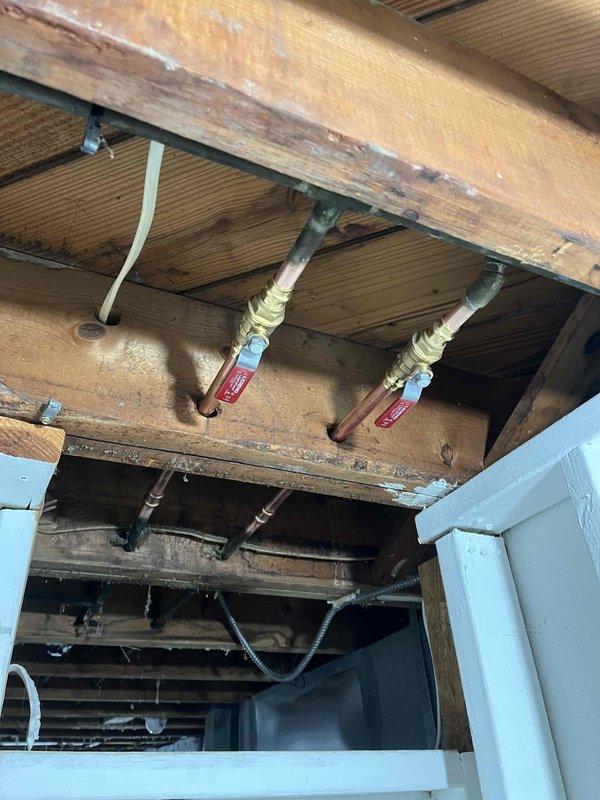 Replaced leaking hot and cold shut-off valves in basement that supplied bathroom fixtures. Removed corroded copper pipes and valve assembly, installing new quarter-turn valves with proper brass fittings. Tested system for proper operation and verified no leaks at connection points.