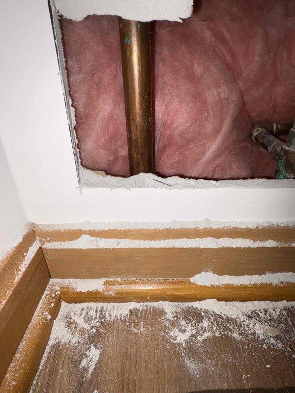 Responded to a water leak call at a residential property where water was dripping from a pipe joint in the basement. Upon inspection, discovered a section of copper supply line with visible oxidation and corrosion requiring access through drywall. Extracted a small metal pin that had punctured the pipe, repaired the damaged section, and verified system integrity with pressure testing before departing.