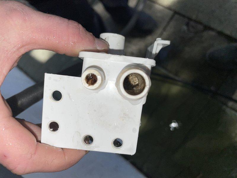 Responded to a callback for persistent system issue. Inspected interior HVAC components with access panel removed, using Fieldpiece multimeter which displayed a reading of 22. Discovered white plastic connector with significant contamination/residue buildup in connection ports that was likely causing system malfunction.